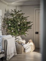 Christmas tree with gifts in neutral seating room