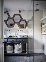 Rustic bathroom in neutral tones featuring pentagonal mirrors