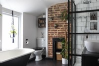 Family bathroom with roll top bath and crittall style shower, exposed brick and chrome accessories