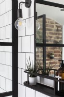 Black and white bathroom with industrial wall lights