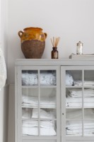 Detail, classic bathroom with painted, antique linen cupboard