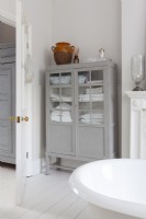 Classic bathroom with painted, antique linen cupboards