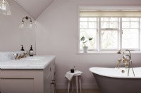 Classic bathroom with freestanding bath and marble inset sink 