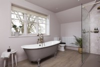 Classic family bathroom with roll top bath, inset marble sink, brass taps and shower