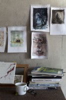 Artist studio detail, paintings, tea and books