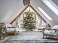 Open plan loft room featuring seating and Christmas tree