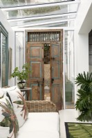 Antique Indian door leading to conservatory style living room