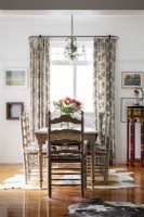 Dining room with embroidered curtains