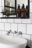 detail of sink, chrome taps and shelf