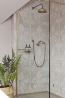 Patterned tiled shower enclosure with brass shower