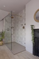 Patterned tiled shower with brass shower.