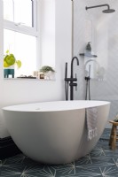 Contemporary freestanding bath in blue and white bathroom