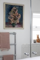 Reflection of floral painting and towel radiator