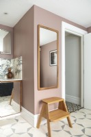 Mirror and stool in pink and grey bathroom