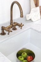 Inset butler sink with brass mixer taps