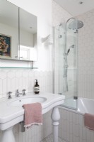 Traditional sink in white bathroom