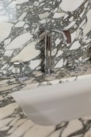Close up of sink with marble surround