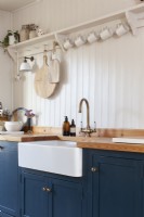 Butler sink with open shelving above in country kitchen
