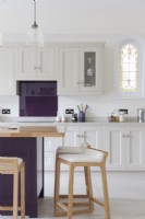 Purple and grey shaker kitchen with stained glass window