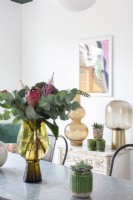 Close up of vase and flowers on dining table