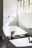 Modern bathtub with shelf tray for accessories.