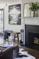 Seating area with fireplace and artwork.