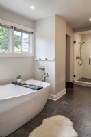 Modern white bathroom with bathtub and shower.