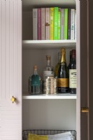 Pink kitchen cabinet with brass handles
