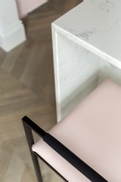 Marble kitchen island with pink bar stool