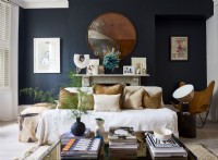 Living room with dark walls, art and natural toned soft furnishings.