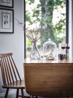 Retro flower and glassware arrangement on dining table