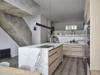 Modern kitchen and island unit featuring concrete stairway