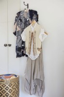 detail of clothes displayed in a bedroom .