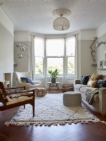 A contemporary living room with an eclectic mix of furniture.