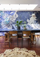 Dining table against a designer wallpapered feature wall. 