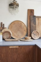 A collection of chopping boards on a stone  kitchen surface .