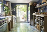 kitchen with a tiled floor and wood shelving .