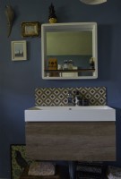 Modern sink with a blue painted wall. 