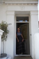 The owner standing in her front doorway. 