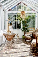 Victorian conservatory or artist room  with a tiled floor and vintage furniture . 