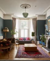 Living room in a victorian house with dark walls. 
