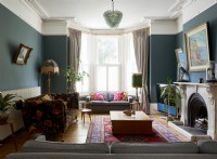 Living room in a victorian villa with velvet sofa 