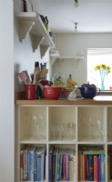 detail of kitchen shelves with glasses and books. 
