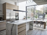 Modern open plan kitchen and dining room with glass bi fold doors
