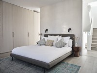 Modern bedroom with bed in muted tones