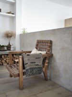 Wooden armchair with grey throw