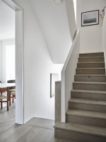 Hallway landing in muted tones with wooden staircase