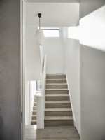 Minimal staircase and hall in muted tones & lots of natural light