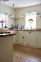 Kitchen with cream shaker style cupboards. 