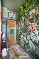 Jungle themed childrens bedroom with tropical patterned wallpaper